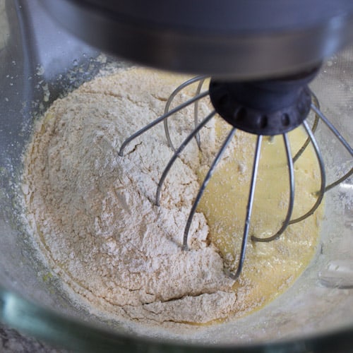 Adding flour to cupcake batter