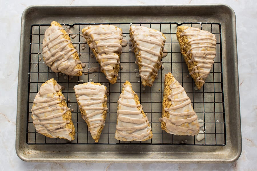 Pumpkin walnut scones on a cooling rack all made sitting on a tray