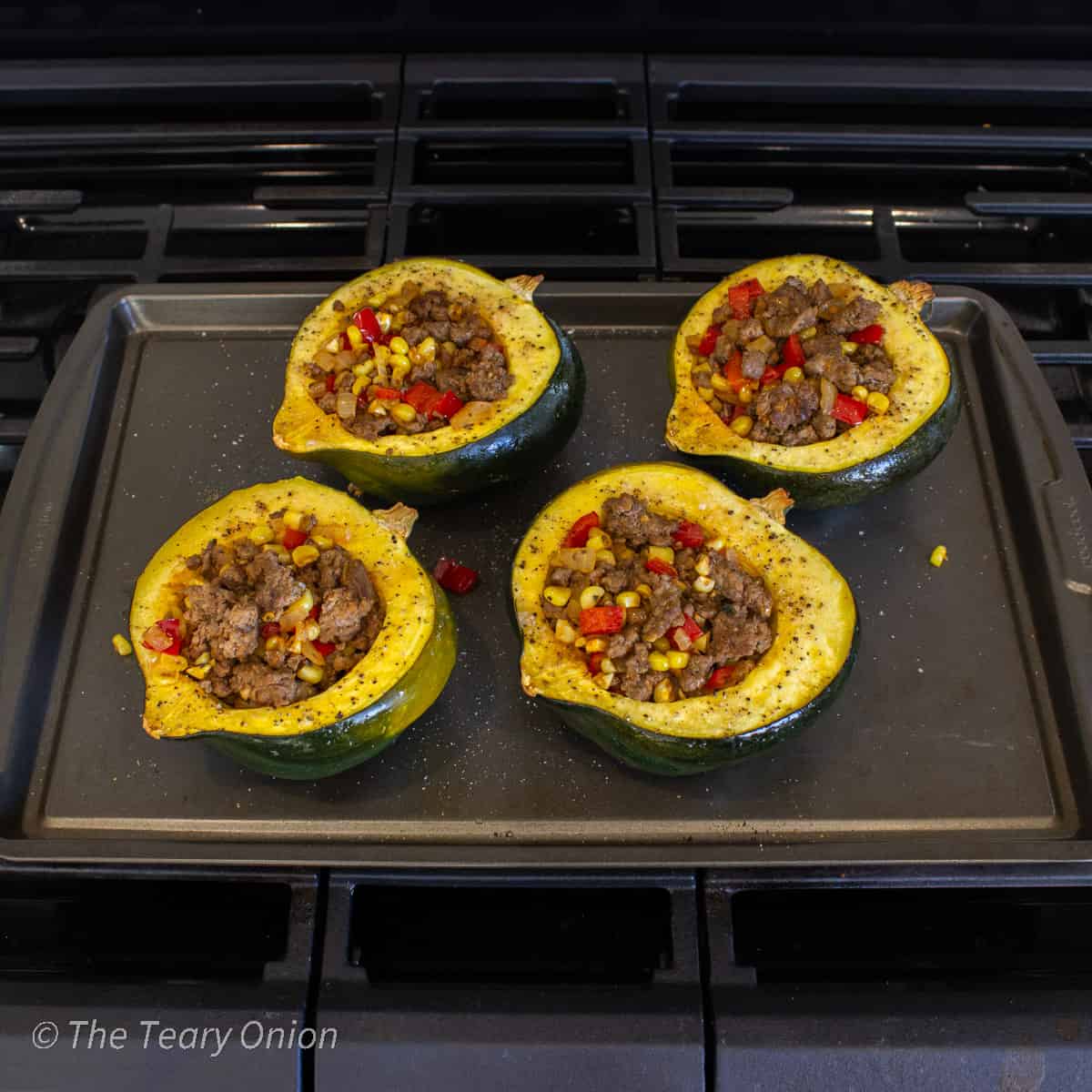 Roasted acorn squash halves stuffed with ground beef and veggies.
