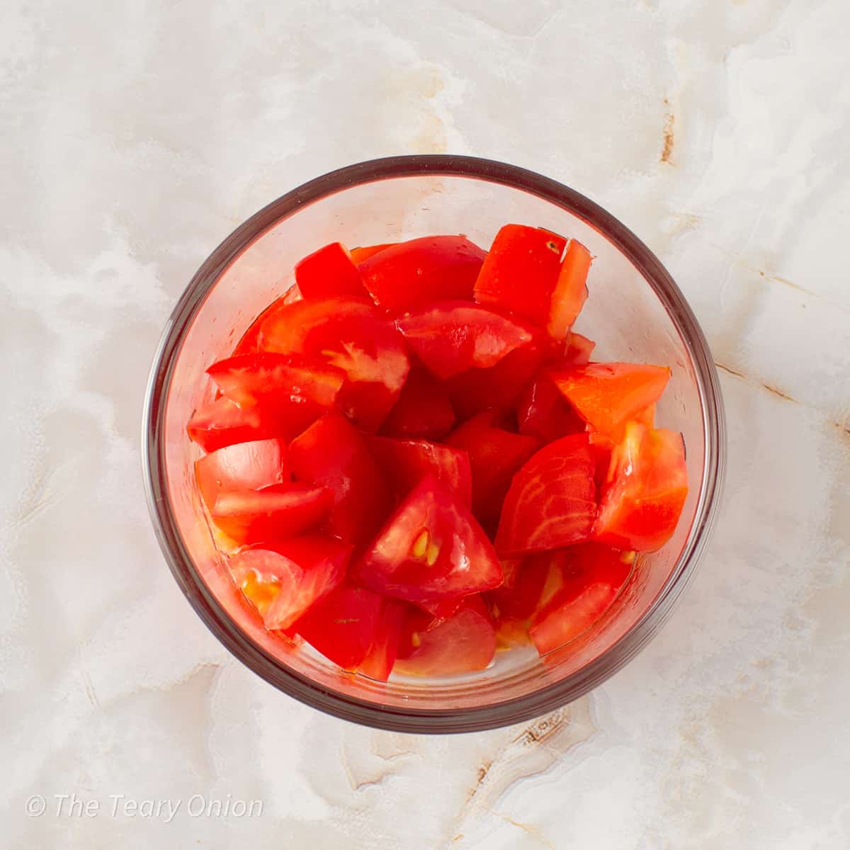 Diced tomatoes in a glass dish.