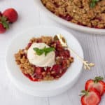 strawberry basil crisp on a plate with a scoop of ice cream on top