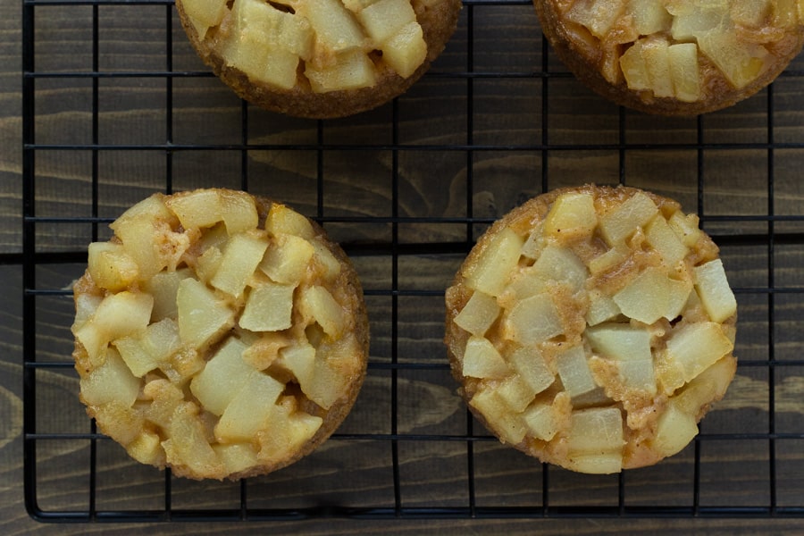 pear upside down cakes on a cooling rack