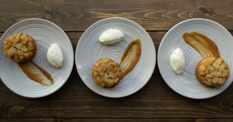 three plates of plated pear upside down cakes