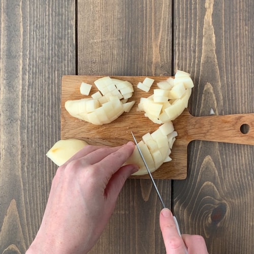 diced pears on a small wooden cutting board
