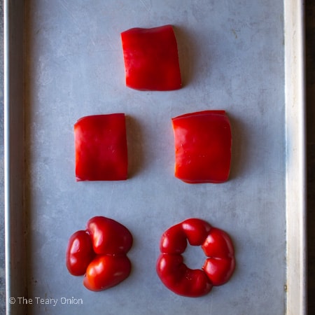 cut up raw red bell pepper on a baking sheet