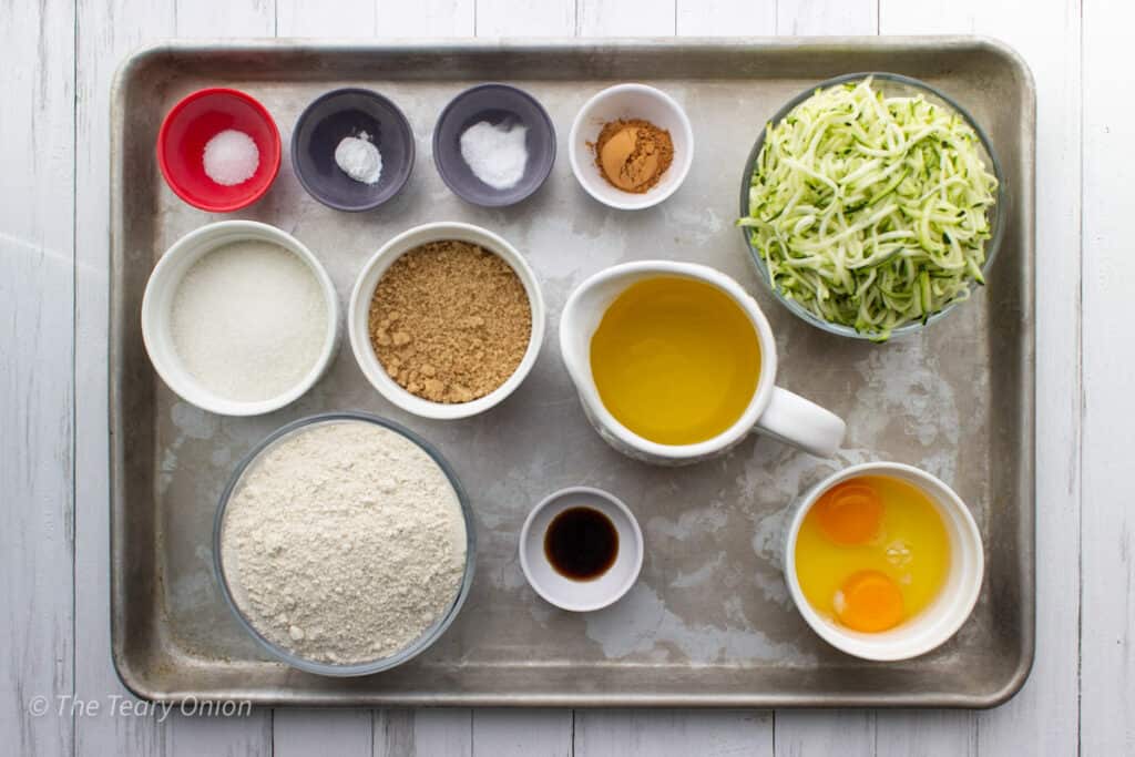 ingredients for whole wheat zucchini muffins on a tray.